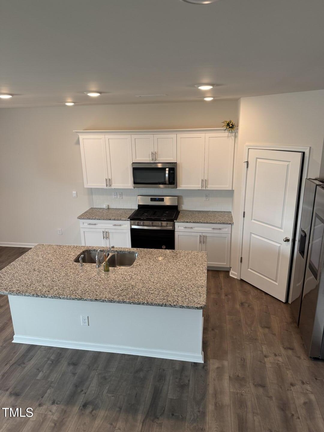 2018 Fletchers Ridge Drive Durham, NC 27703 - Photo 21 of 41 a kitchen with kitchen island granite countertop a refrigerator oven a sink and dishwasher