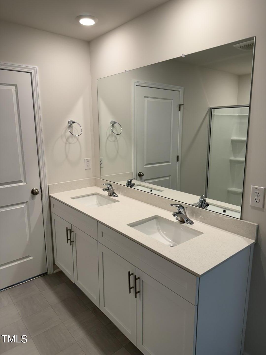 2018 Fletchers Ridge Drive Durham, NC 27703 - Photo 25 of 41 a bathroom with double sink and a mirror