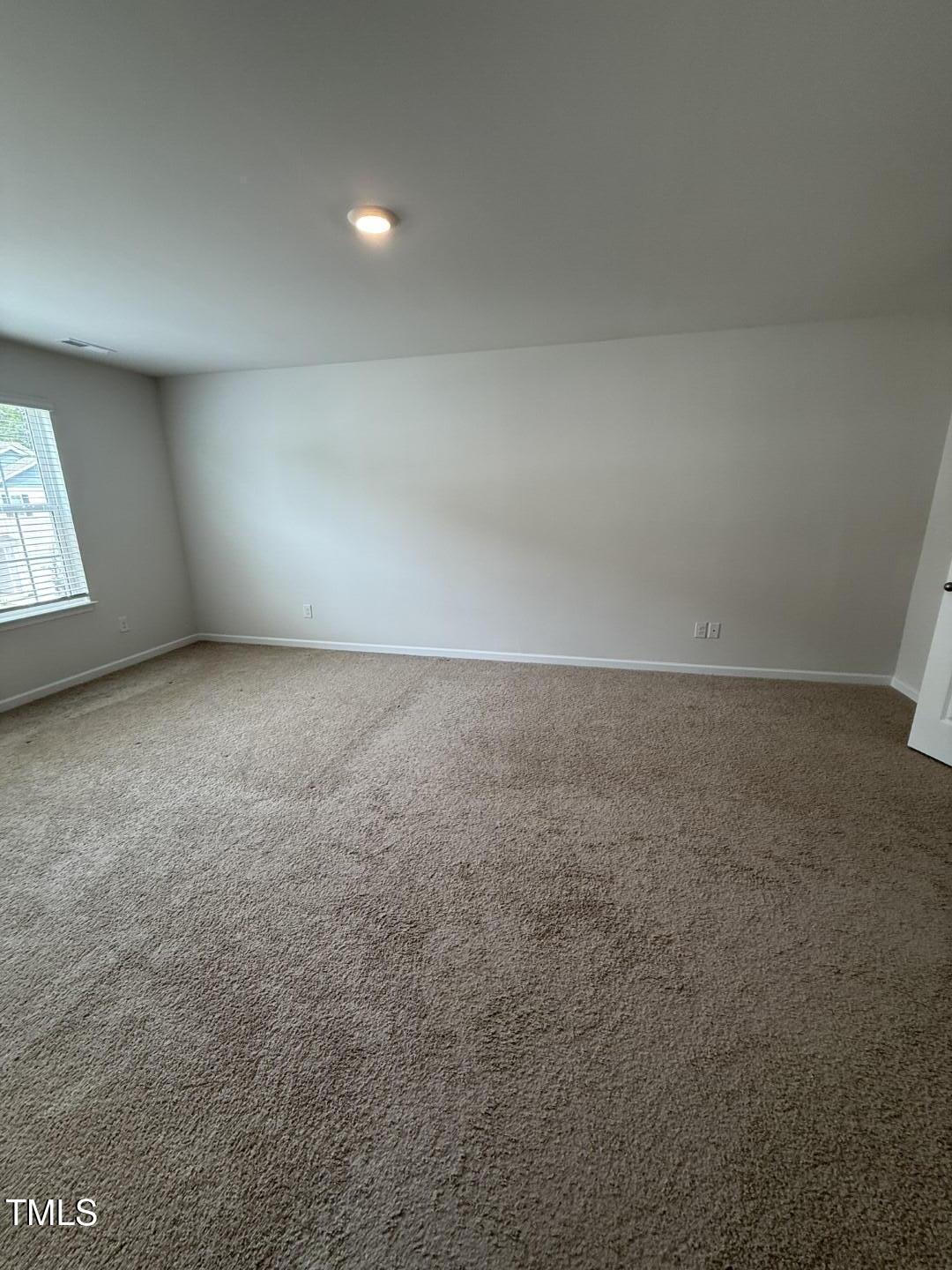 2018 Fletchers Ridge Drive Durham, NC 27703 - Photo 26 of 41 an empty room with a natural light