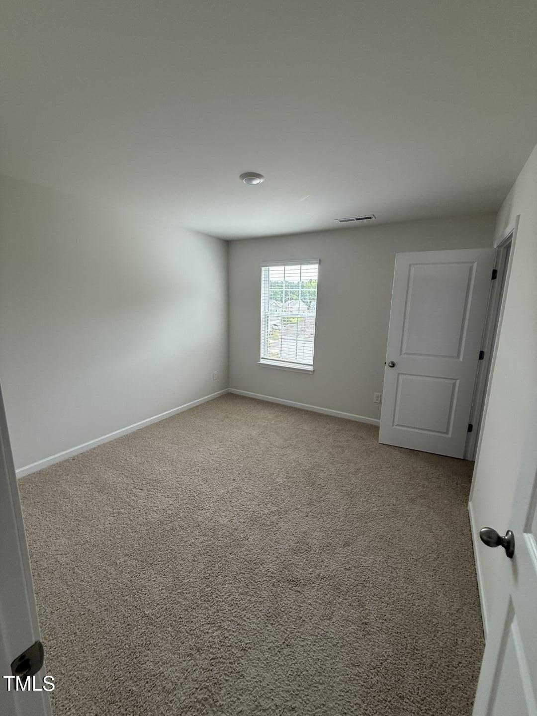 2018 Fletchers Ridge Drive Durham, NC 27703 - Photo 30 of 41 an empty room with windows and closet