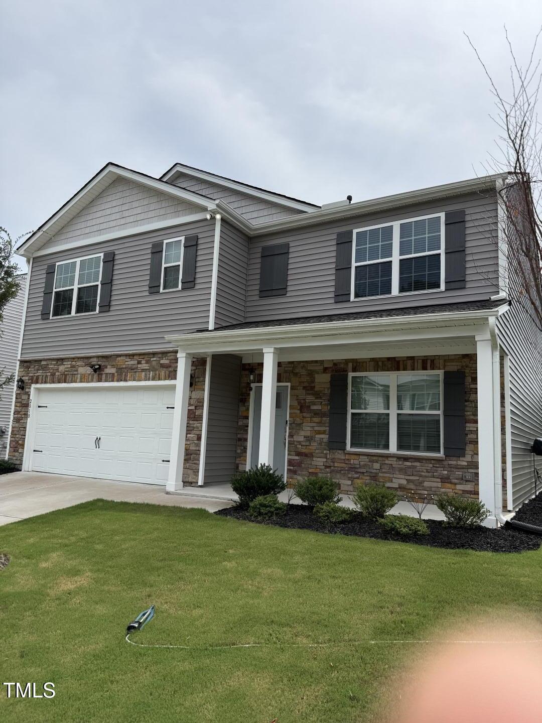 2018 Fletchers Ridge Drive Durham, NC 27703 - Photo 3 of 41 a front view of a house with a garden