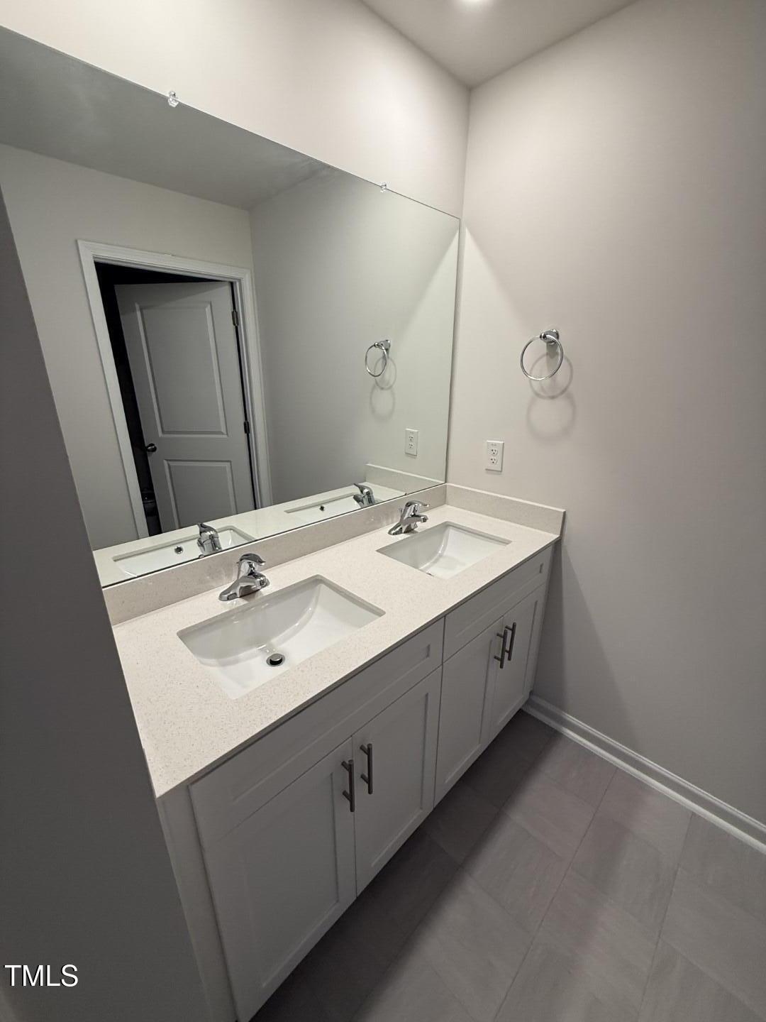 2018 Fletchers Ridge Drive Durham, NC 27703 - Photo 33 of 41 a spacious bathroom with a double vanity sink and mirror