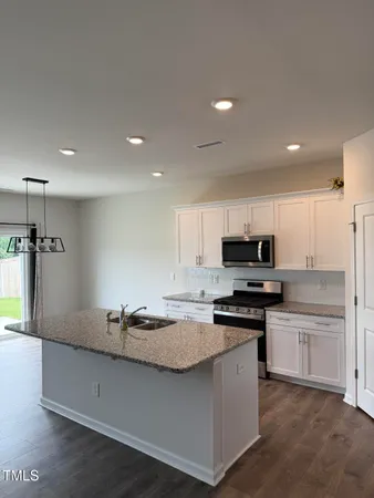 a kitchen with stainless steel appliances a sink stove and refrigerator
