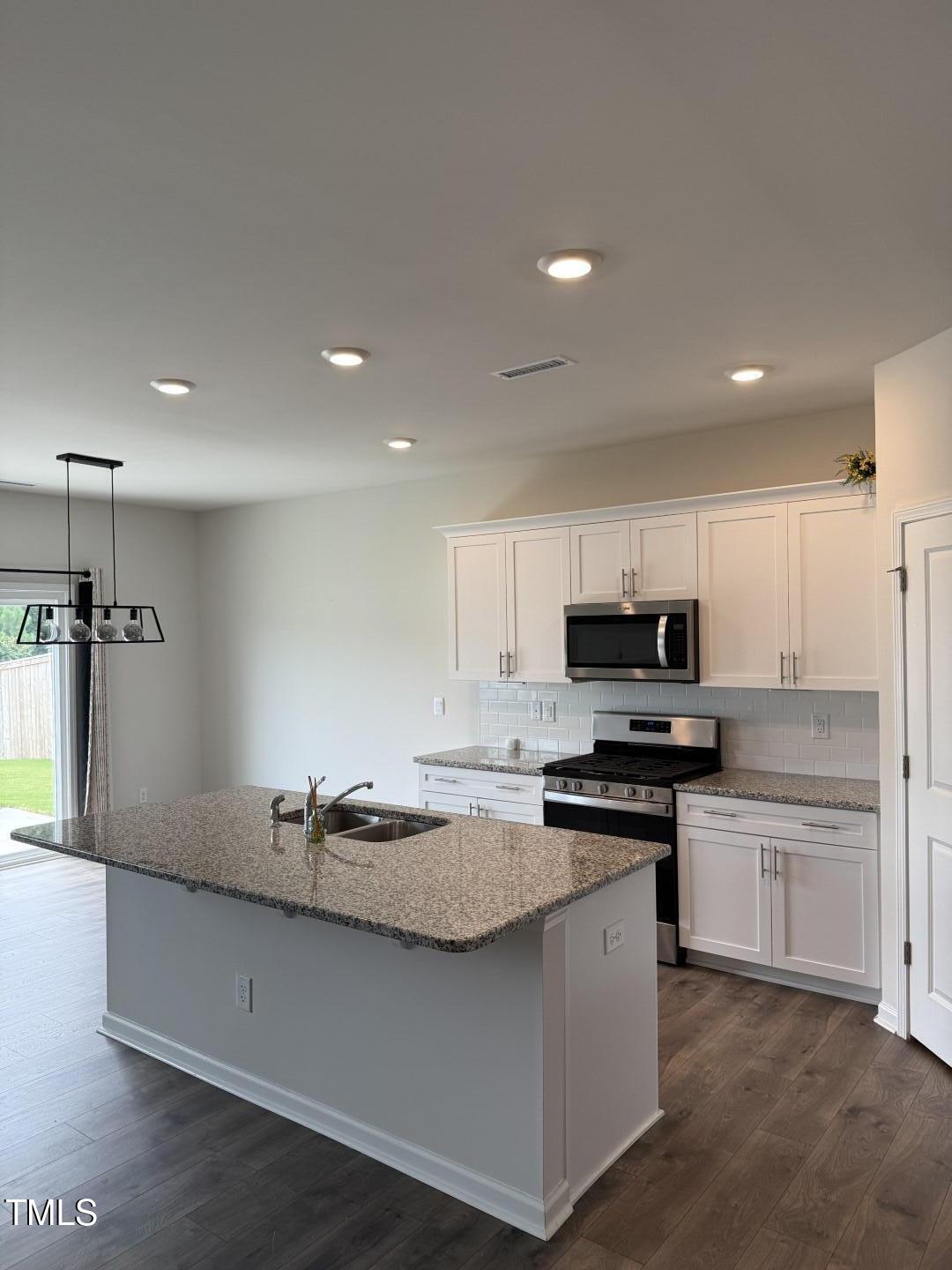2018 Fletchers Ridge Drive Durham, NC 27703 - Photo 7 of 41 a kitchen with stainless steel appliances a sink stove and refrigerator
