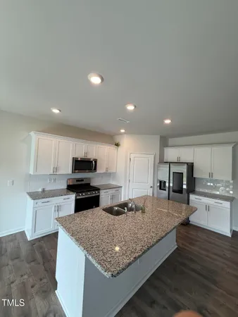 a kitchen with granite countertop stainless steel appliances and wooden cabinets