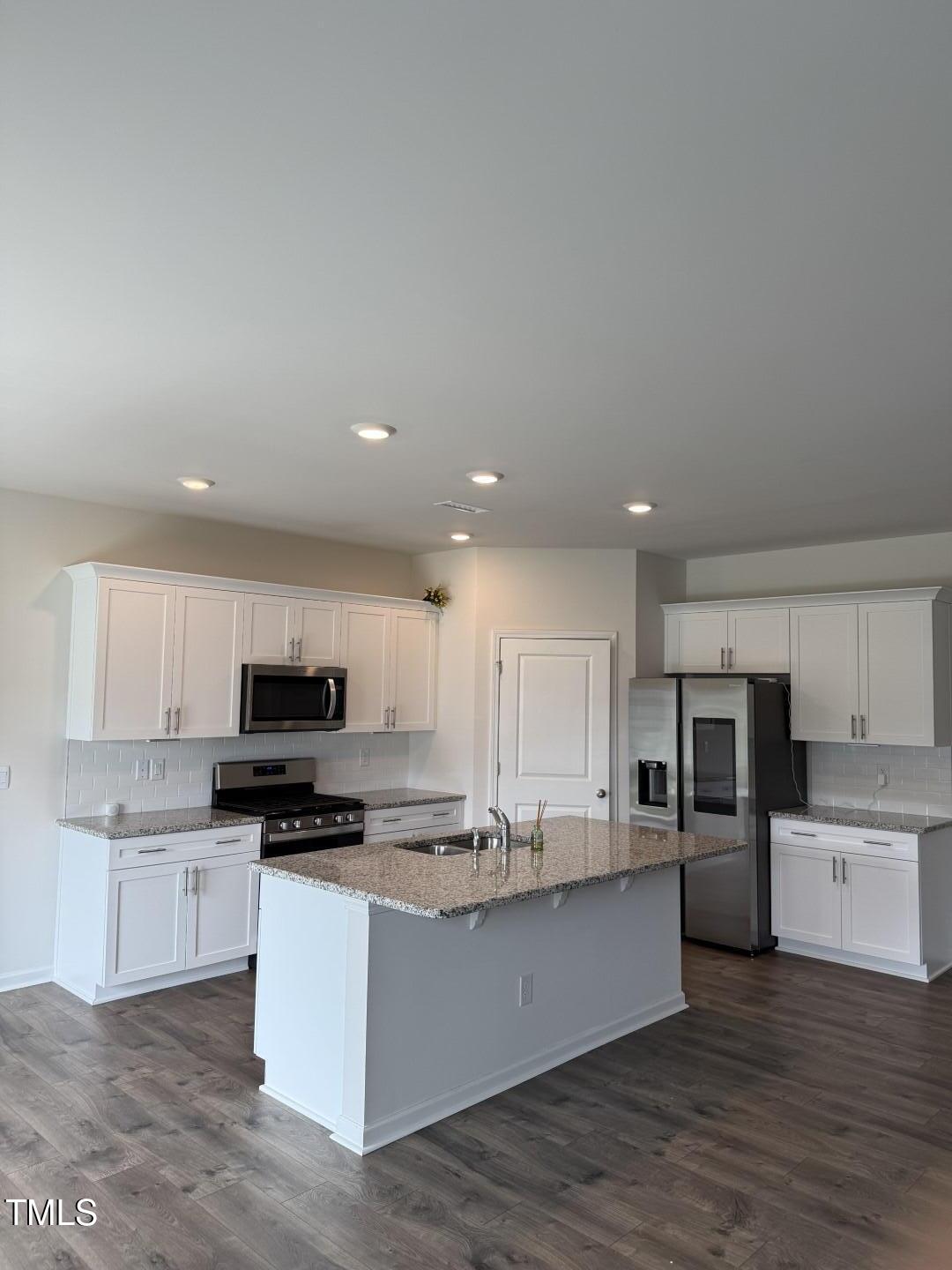 2018 Fletchers Ridge Drive Durham, NC 27703 - Photo 10 of 41 a kitchen with stainless steel appliances granite countertop a stove top oven a sink and white cabinets