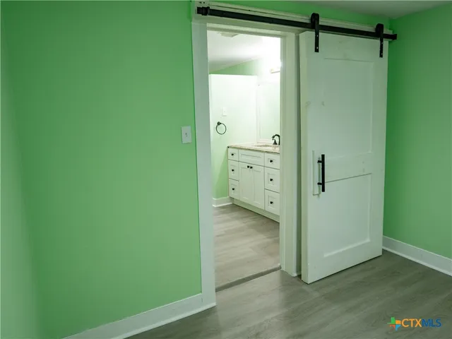 a view of a closet area with hardwood