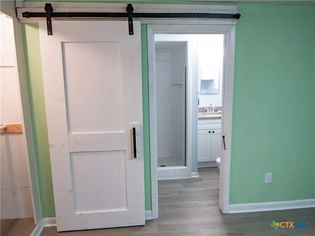 a view of front door with wooden floor