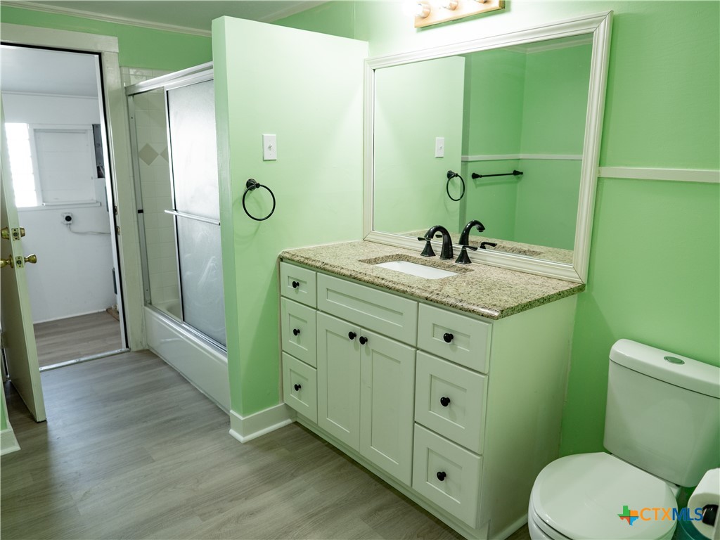 312 Jefferson Avenue Port O'Connor, TX 77982 - Photo 21 of 22 a bathroom with a granite countertop sink toilet and shower