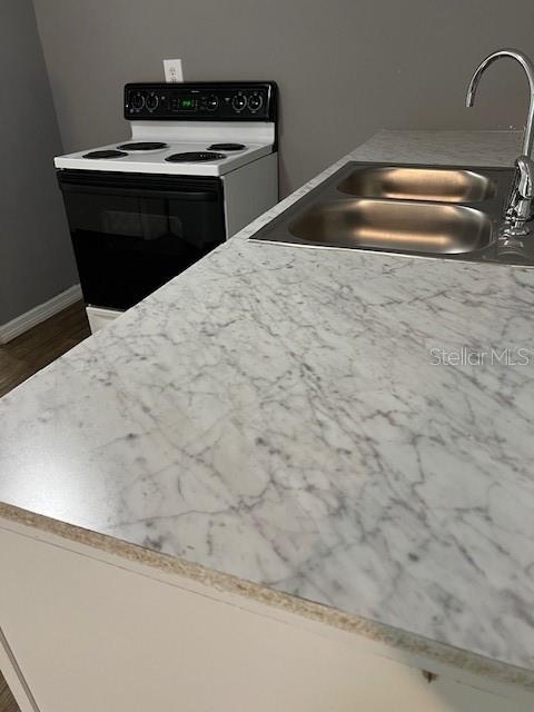 1537 Poe Road Lake Wales, FL 33898 - Photo 11 of 16 a kitchen with a sink and cabinets