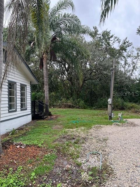 1537 Poe Road Lake Wales, FL 33898 - Photo 5 of 16 a view of a backyard with large trees