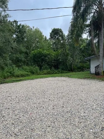 a view of a yard with potted plants