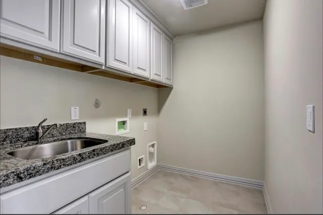 a kitchen with sink cabinets and utility