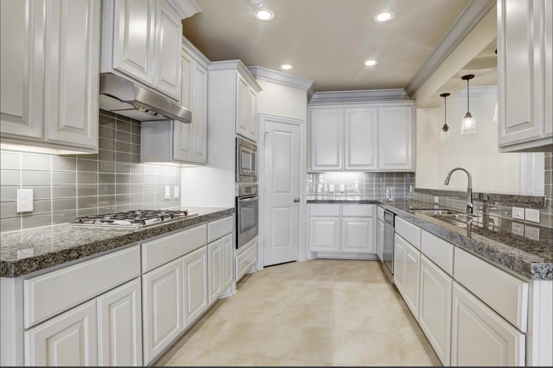 13621 Teal Bluff Lane Houston, TX 77077 - Photo 3 of 29 a kitchen with granite countertop sink stainless steel appliances and cabinets