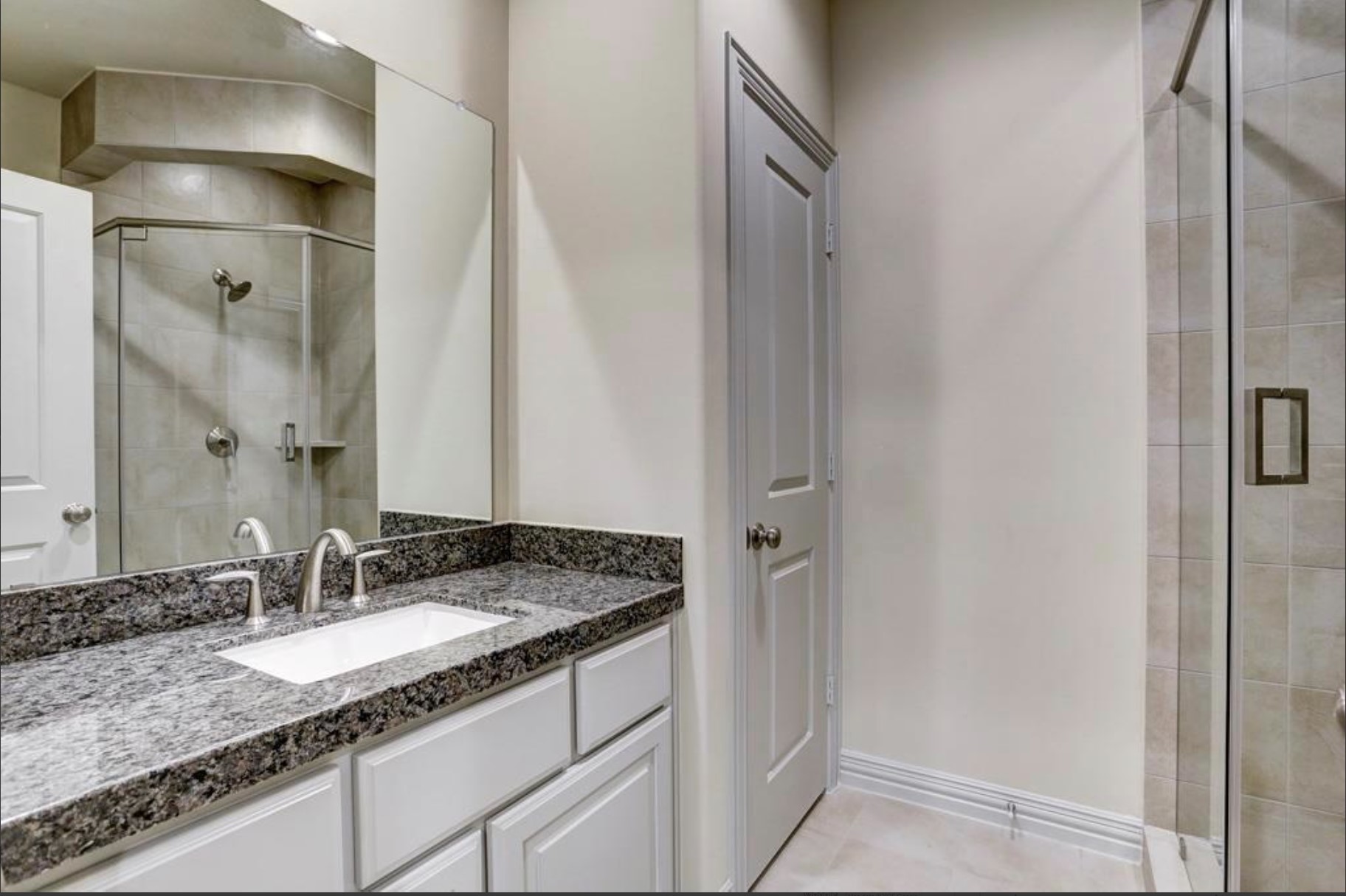 13621 Teal Bluff Lane Houston, TX 77077 - Photo 8 of 29 a bathroom with a granite countertop sink and a mirror
