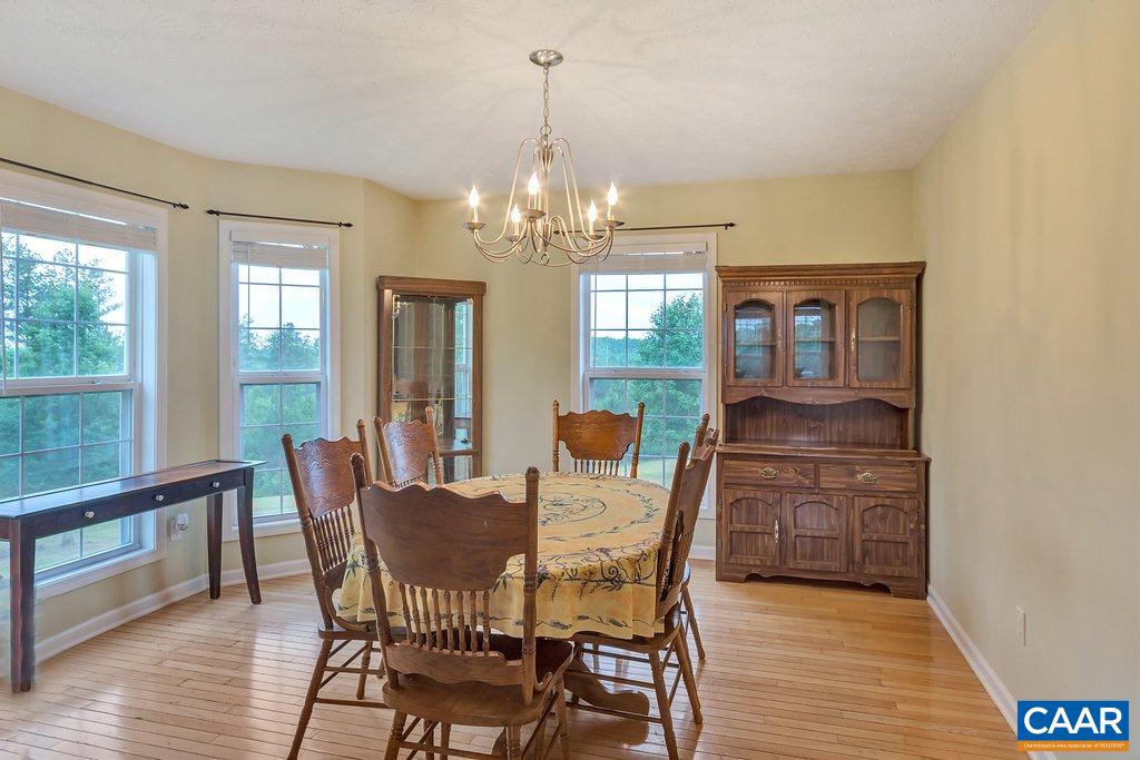 8424 Chestnut Grove Road Esmont, VA 22937 - Photo 12 of 42 a view of a dining room with furniture window and wooden floor