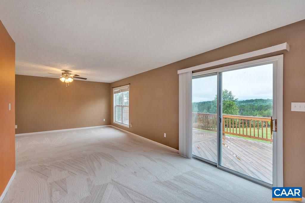 8424 Chestnut Grove Road Esmont, VA 22937 - Photo 15 of 42 a view of empty room with wooden floor and fan