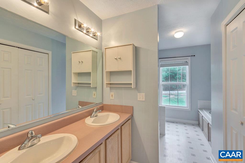 8424 Chestnut Grove Road Esmont, VA 22937 - Photo 17 of 42 a bathroom with a granite countertop sink and a mirror