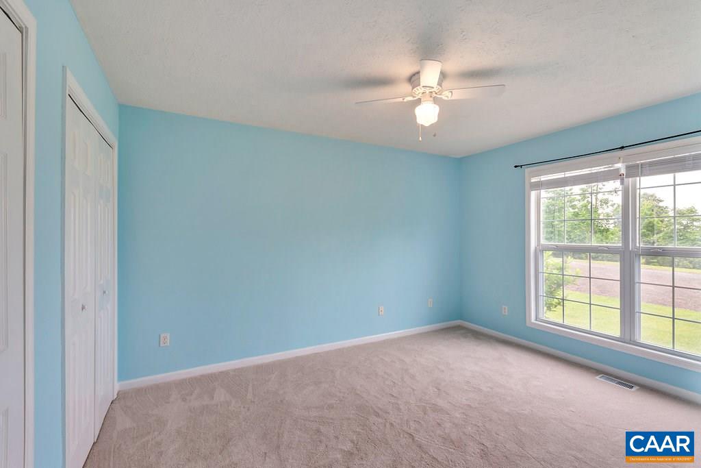 8424 Chestnut Grove Road Esmont, VA 22937 - Photo 20 of 42 a view of a livingroom with a ceiling fan and window