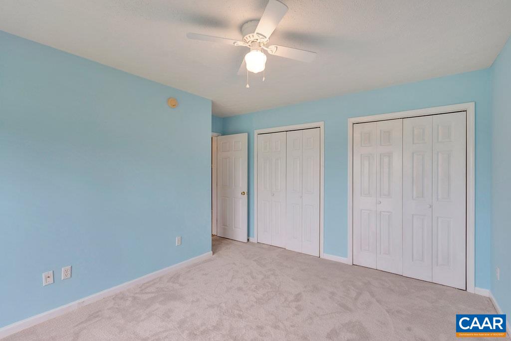 8424 Chestnut Grove Road Esmont, VA 22937 - Photo 21 of 42 an empty room with closet and a ceiling fan