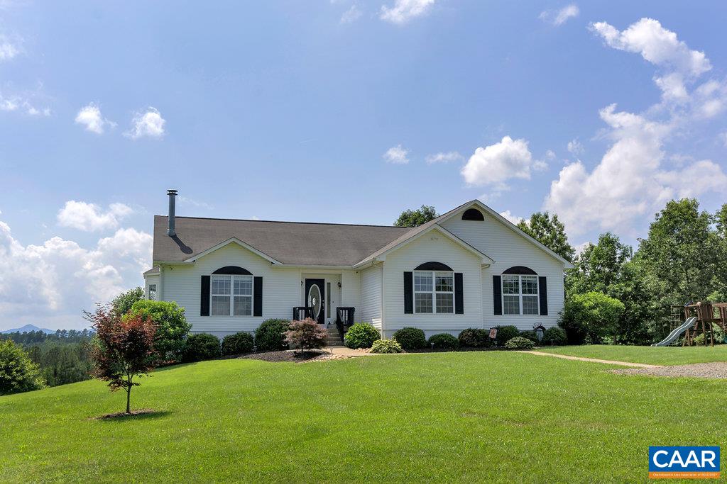 8424 Chestnut Grove Road Esmont, VA 22937 - Photo 36 of 42 a front view of a house with a yard and garage