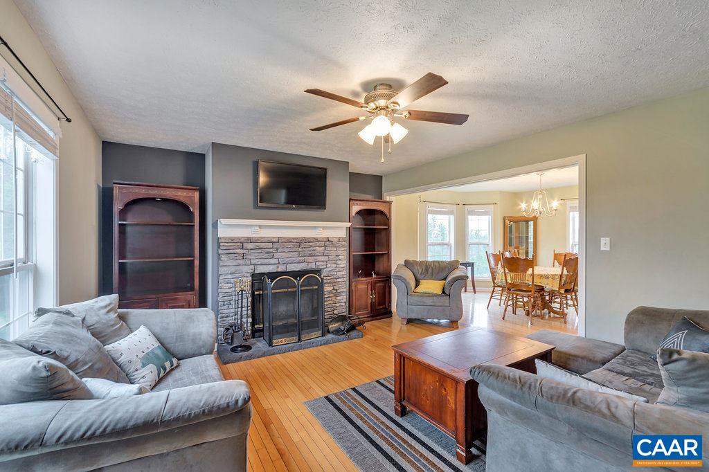 8424 Chestnut Grove Road Esmont, VA 22937 - Photo 5 of 42 a living room with furniture a fireplace and a flat screen tv