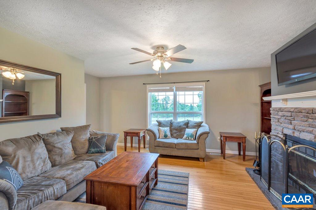 8424 Chestnut Grove Road Esmont, VA 22937 - Photo 6 of 42 a living room with furniture and a fireplace