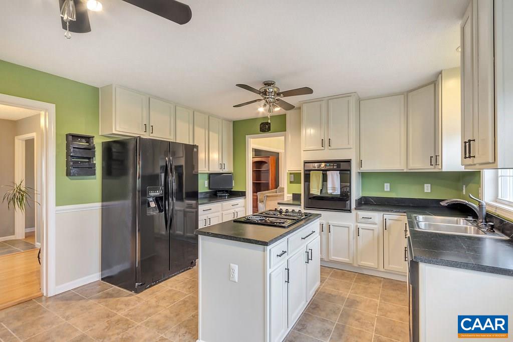 8424 Chestnut Grove Road Esmont, VA 22937 - Photo 7 of 42 a kitchen with stainless steel appliances granite countertop a refrigerator stove microwave and sink
