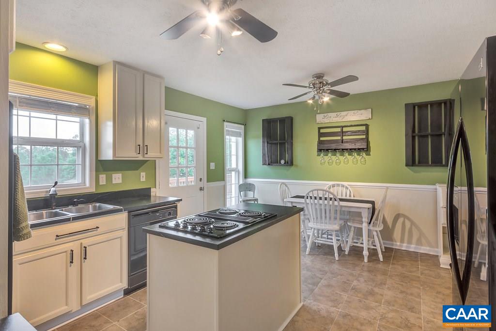 8424 Chestnut Grove Road Esmont, VA 22937 - Photo 8 of 42 a kitchen with a dining table and chairs