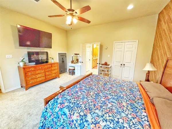 a living room with a bed furniture and a flat screen tv