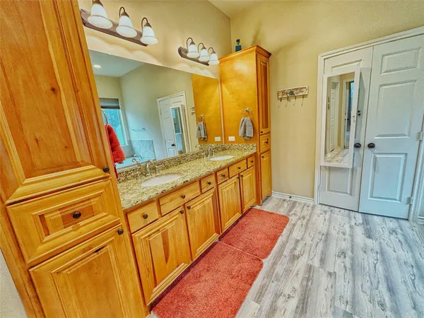 a bathroom with a sink a mirror and a shower