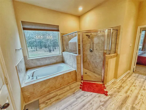 a bathroom with a bathtub and a shower