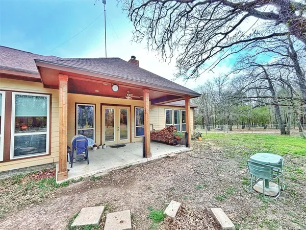 a view of a house with a backyard and a garden