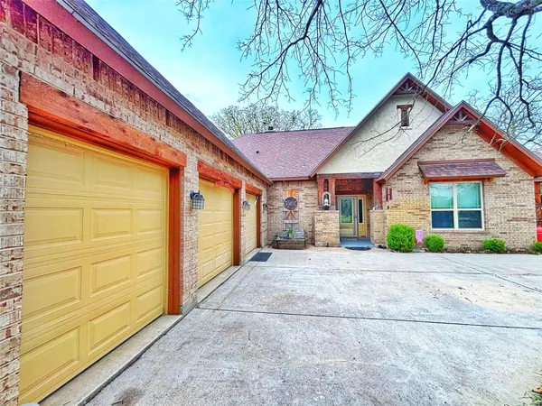 a view of a house with a yard and tree s