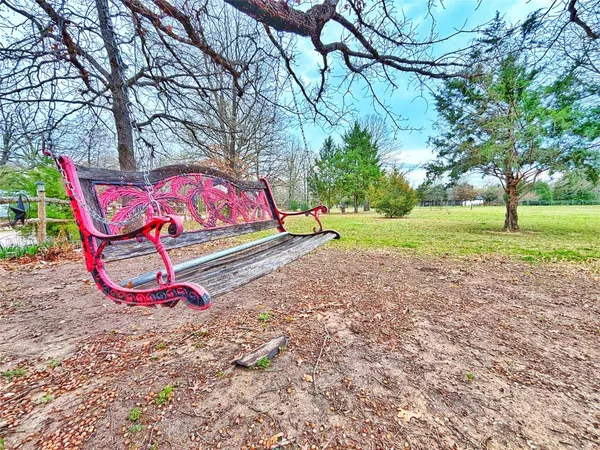 a park with trees and outdoor seating
