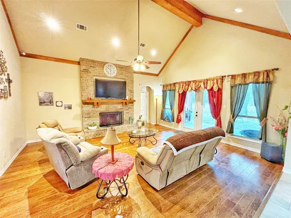 a living room with furniture a rug and a flat screen tv