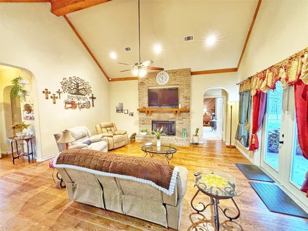 a living room with lots of furniture and a wooden floor