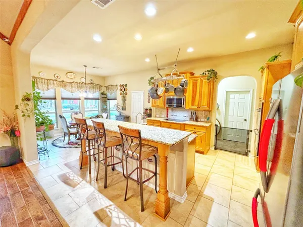 a dining room filled with glass top table and chairs