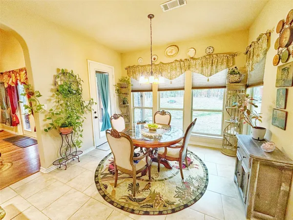 a dining room with couches chairs and a coffee table