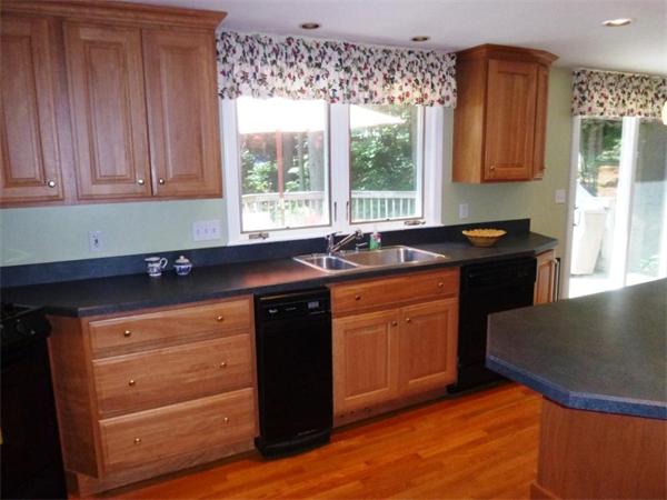 4 Olde Lantern Road Acton, MA 01720 - Photo 8 of 19 a kitchen with granite countertop a sink cabinets and wooden floor