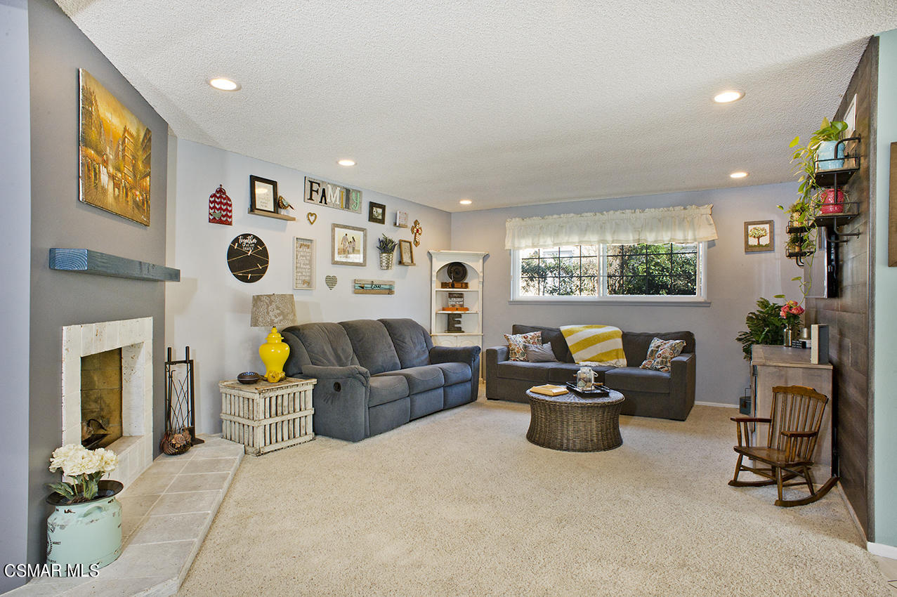 2386 Fitzgerald Road Simi Valley, CA 93065 - Photo 3 of 28 a living room with furniture a flat screen tv and a fireplace
