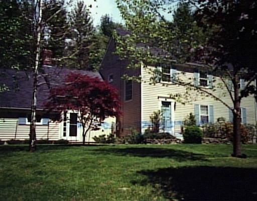 252 West Mountain Road Ridgefield, CT 06877 - Photo 1 of 1 a view of a white house next to a yard with big trees