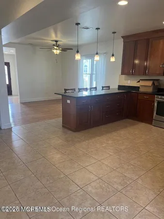 a kitchen with stainless steel appliances granite countertop a stove a refrigerator and a wooden cabinets