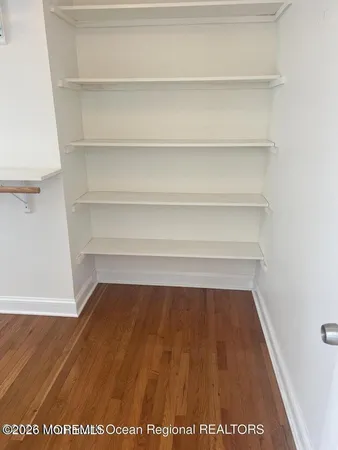 a bathroom with a granite countertop toilet a sink and a mirror