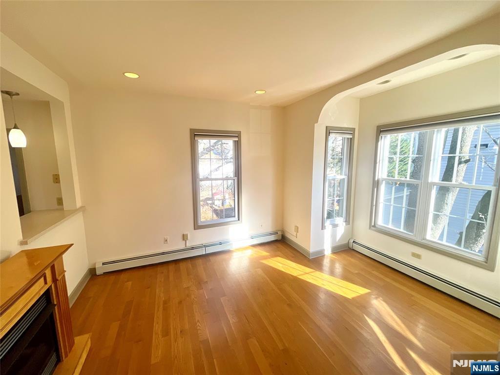 49 East Passaic Avenue, Unit 2 Rutherford, NJ 07070 - Photo 10 of 23 an empty room with wooden floor and windows