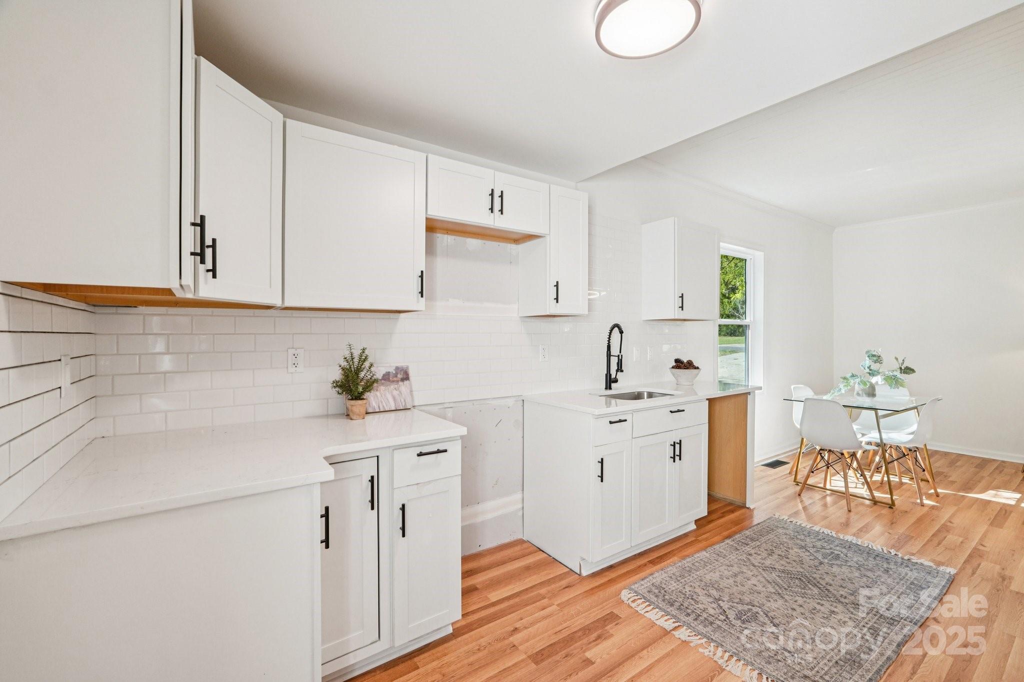 38 6th Street York, SC 29745 - Photo 4 of 34 a kitchen with a sink stove and cabinets