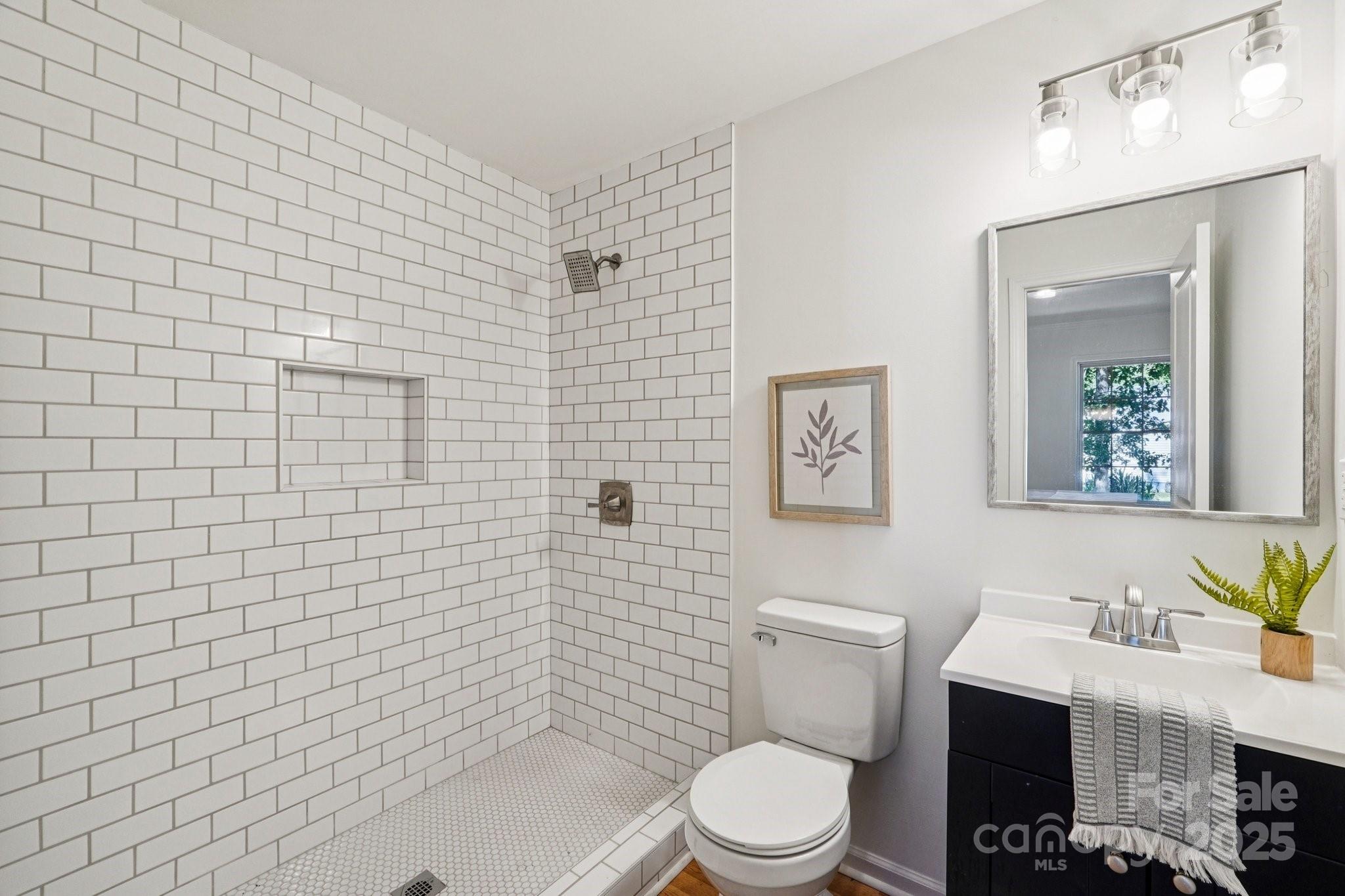 38 6th Street York, SC 29745 - Photo 6 of 34 a bathroom with a toilet a sink and mirror