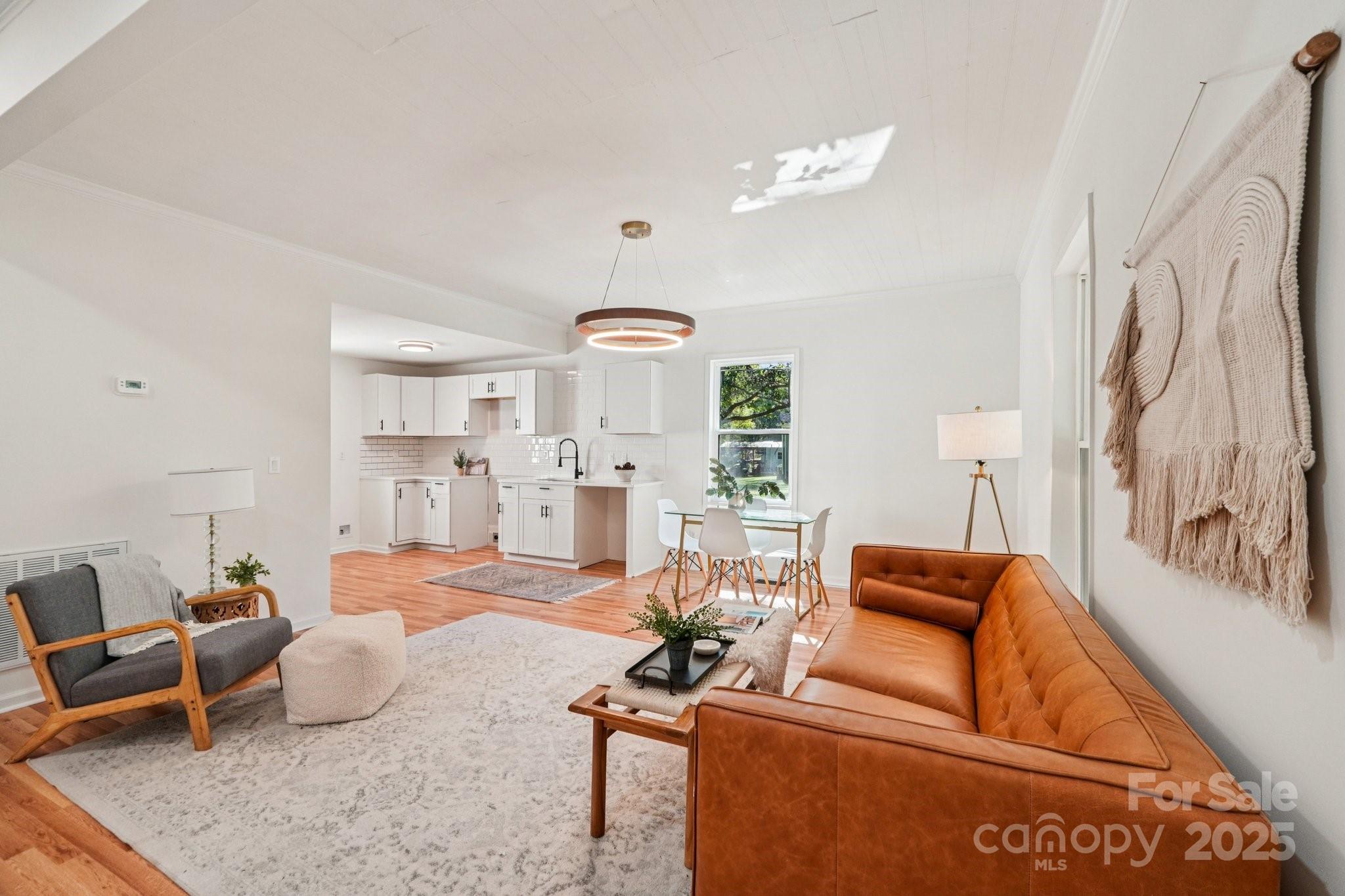 38 6th Street York, SC 29745 - Photo 8 of 34 a living room with furniture a rug and white walls