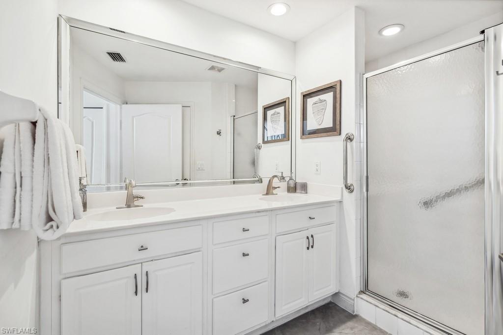 170 Lenell Road, Unit 403 Fort Myers Beach, FL 33931 - Photo 11 of 23 a bathroom with double sink and a mirror