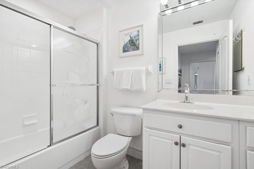 170 Lenell Road, Unit 403 Fort Myers Beach, FL 33931 - Photo 14 of 23 a bathroom with a sink toilet vanity and shower
